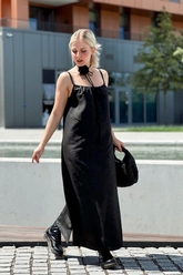 a lady in a black slip dress made of xiangyun silk